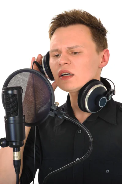 stock image Young man with microphone on white background