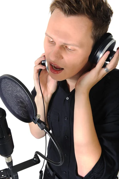 stock image Young man with microphone on white background