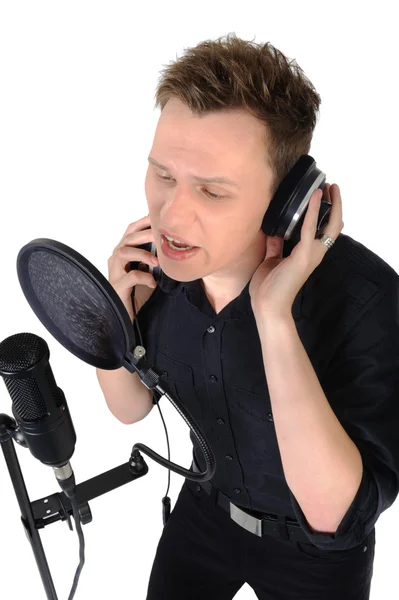 stock image Young man with microphone on white background