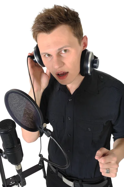 Stock image Young man with microphone on white background