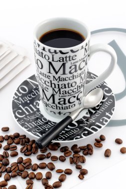 Stylish balck and white coffee mug with brown coffee beans clipart