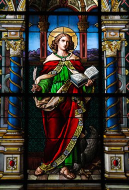 Saint John the Evangelist. Stained glass window created by F. Zettler (1878-1911) at the German Church in Stockholm. clipart