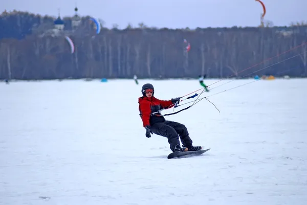 Snowkiting on a frozen lake — Stock Photo, Image