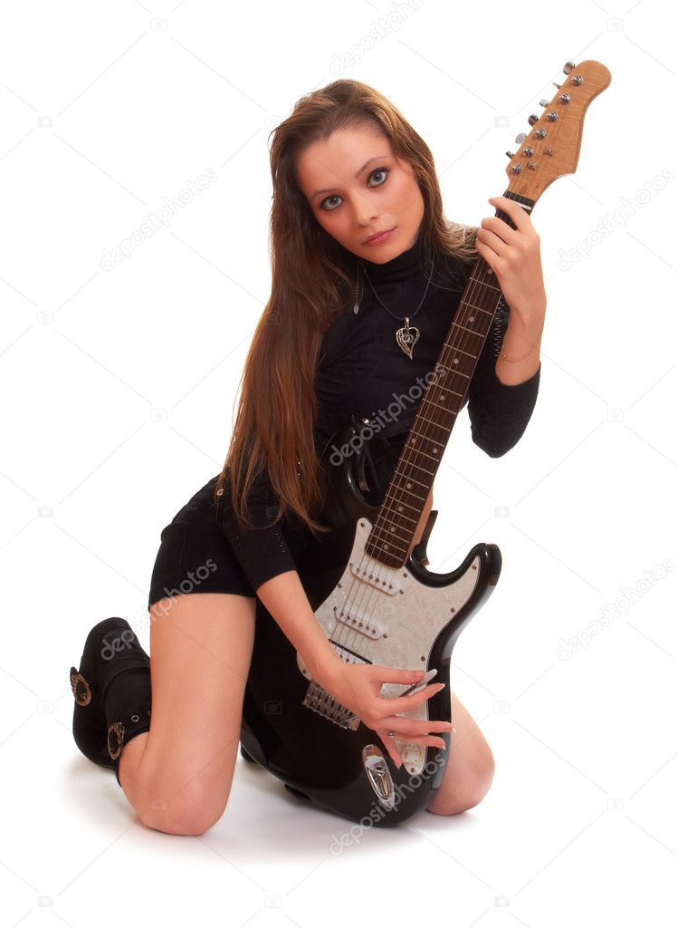 Cute rock girl posing with an electric guitar