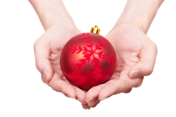 Christmas tree bauble in hands puted together in the shape of a Royalty Free Stock Photos