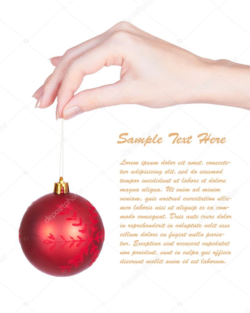 Women's hand holding red christmas-tree ball