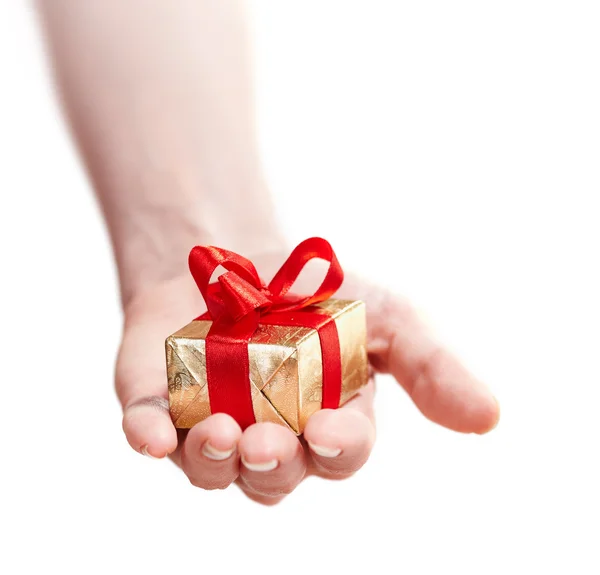 Hand of a girl with a gift isolated on white — Stock Photo, Image