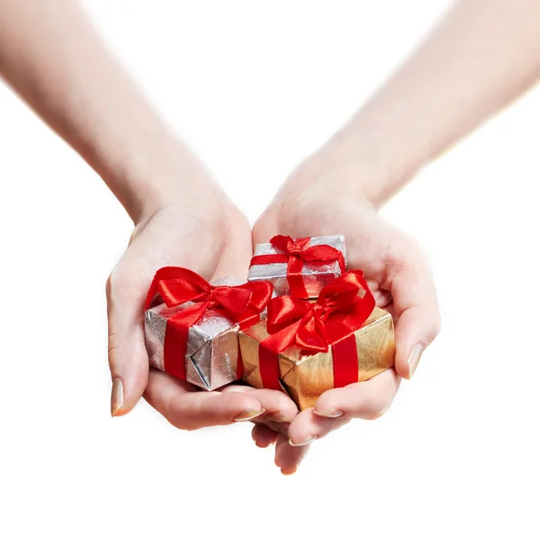Woman hands giving gifts isolated on white Stock Photo