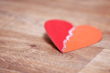 Valentine's day greetings card on the wooden floor. Very shallow focus. clipart