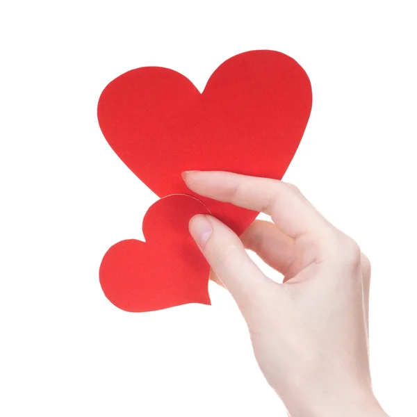 Dois dia dos namorados cumprimentando corações de cartão na mão da menina no branco — Fotografia de Stock