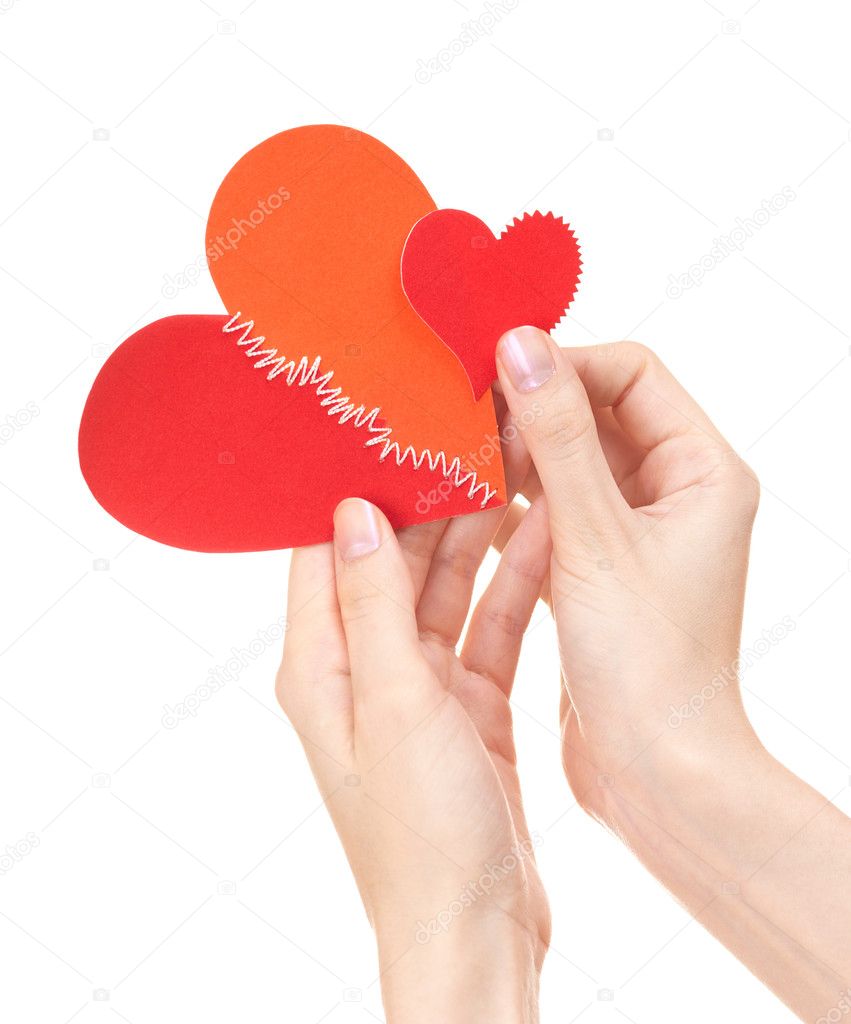 Big and small broken hearts in woman's hands