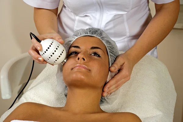 Beautiful young woman getting face massage. — Stock Photo, Image