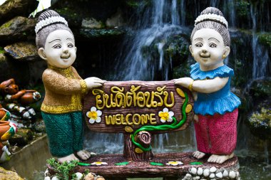 Thai woman holds the sign You're welcome clipart