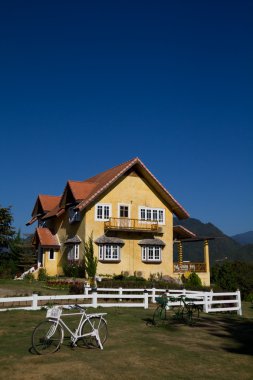 Yellow classic house on hill, pai, maehongson, thailand clipart