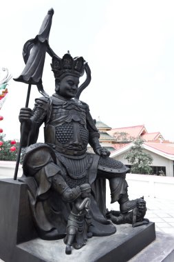 Chinese god sitting statue in chinese temple clipart