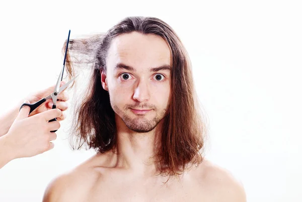 stock image Young joyful man with long hair in barbershop