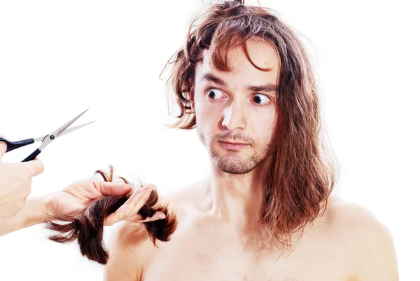 stock image Young frightened man with long hair being terribly clipped