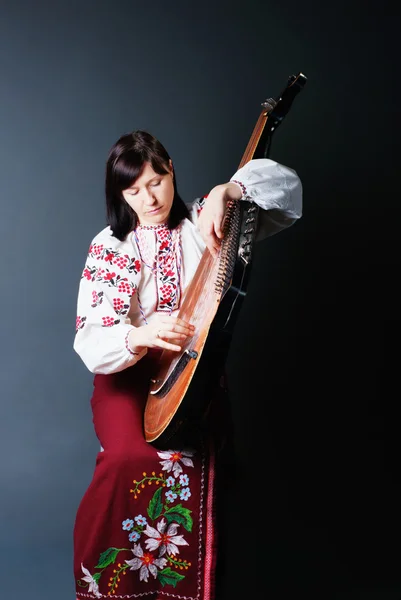 stock image Woman in traditional dress playing the bandura