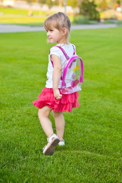 Little pretty girl walks in park — Stock Photo, Image