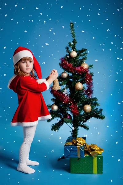 Забавна дівчина Санта прикрашає ялинку — стокове фото