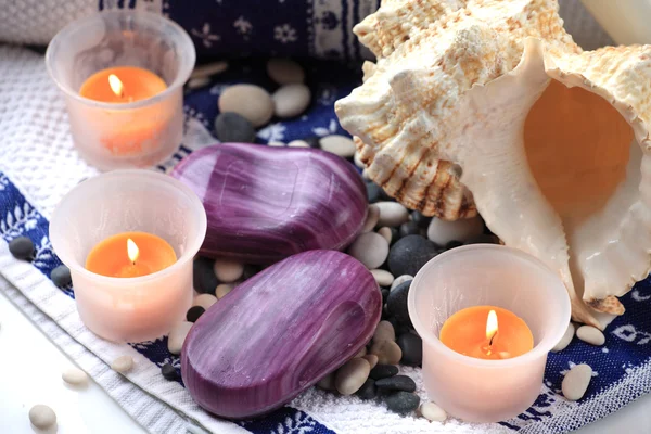 Seashell, soaps and orange candles — Stock Photo, Image