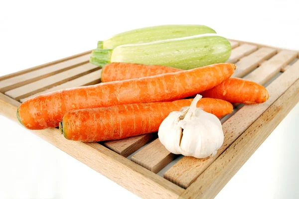 Vegetables on a wooden plate — Stock Photo, Image