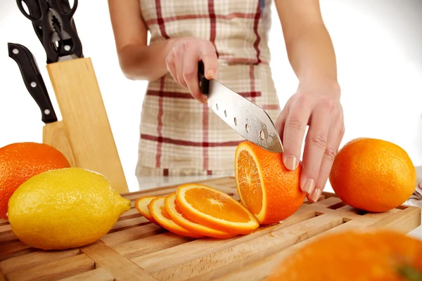 stock image Girl cutting orange closeup
