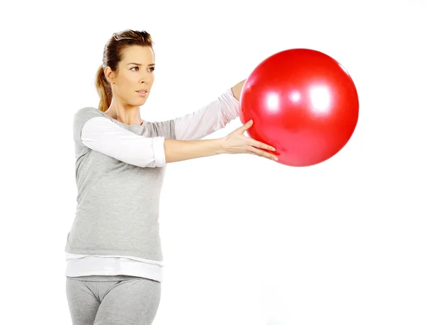 Girl exercising with a red ball 2 — Stock Photo, Image