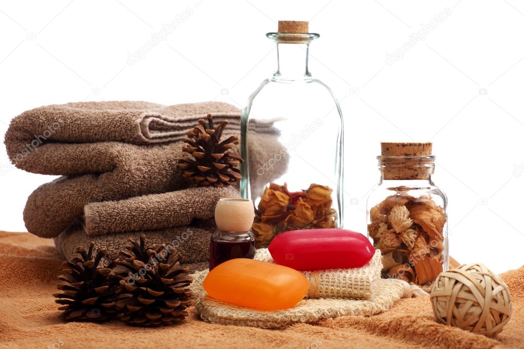 Soaps, towels and pine cones placed on a towels