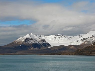 Snow-covered Mountains of Spitsbergen and Ocean clipart