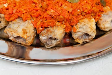 Fried rolled fish with carrot clipart