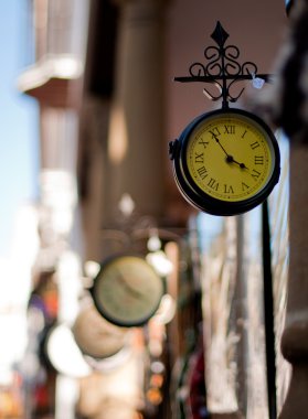 A selection of London Railway clocks for sale outside a shop in Southern Spain. clipart