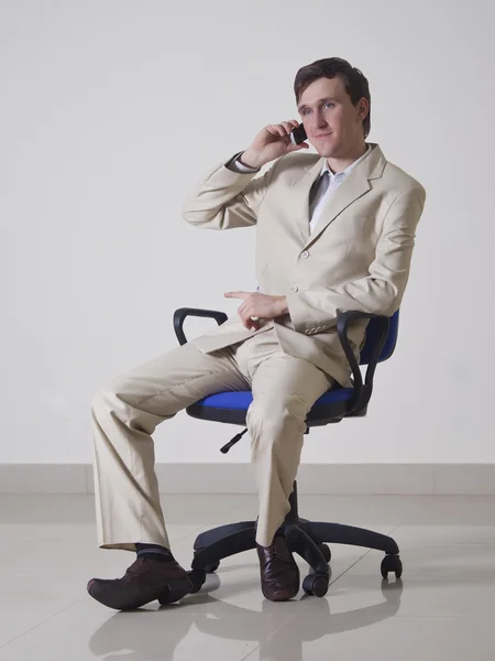 Stock image Young man in office talking on the phone