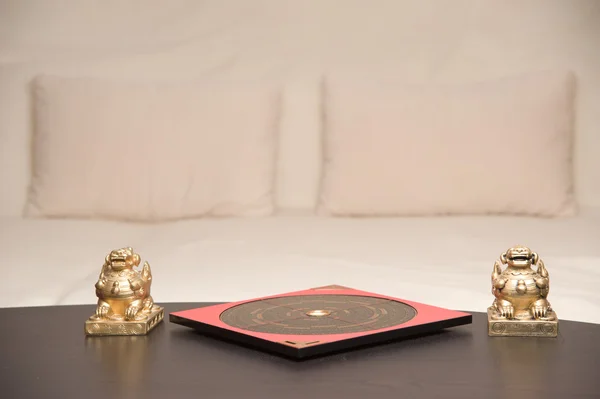 stock image An asian symbol and a Feng Shui compass on a table