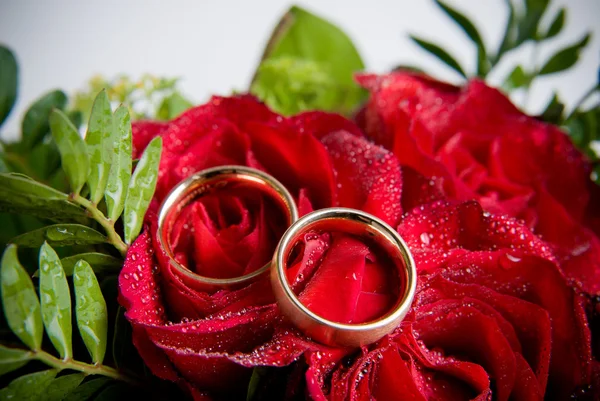 花の上の つのゴールデン結婚指輪のクローズ アップ — ストック写真