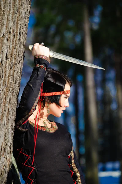 The girl with a dagger — Stock Photo, Image