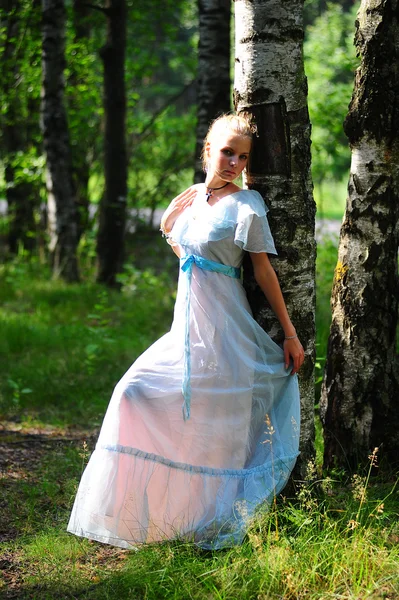 Fiatal lány, egy kék ruhát a parkban — Stock Fotó