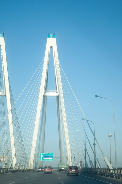 stock image Bridge support through the river against the cloudy sky