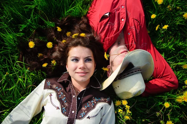 Happy couple lying on a grass — Stock Photo, Image