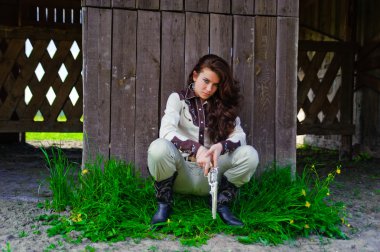 The girl dressed in cowboy's style clipart