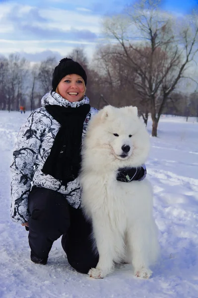 Nainen valkoisen koiran kanssa. — kuvapankkivalokuva