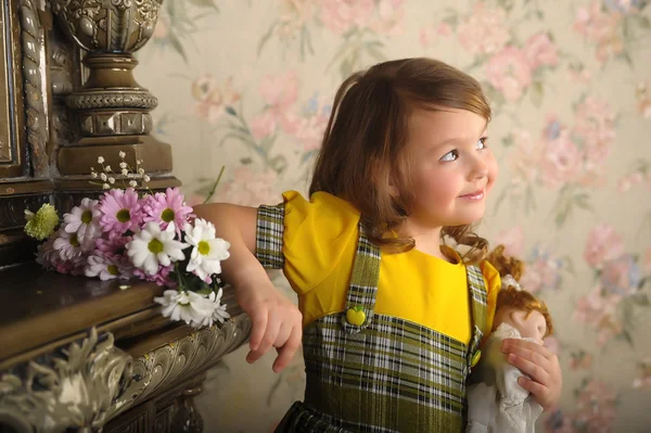 Kleines Mädchen mit einer Puppe in den Händen. — Stockfoto