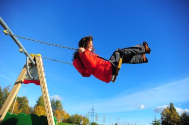 Girl swinging on a swing clipart