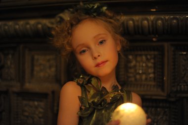 Candlelight portrait of beautiful little girl clipart