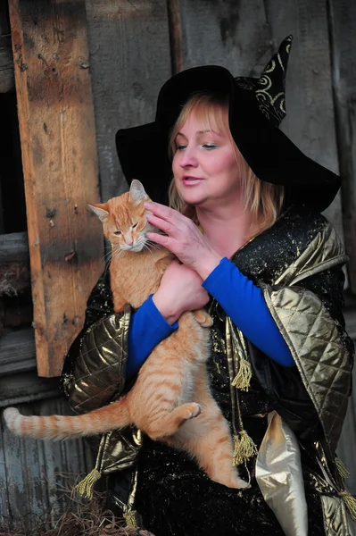 Witch with a red cat — Stock Photo, Image