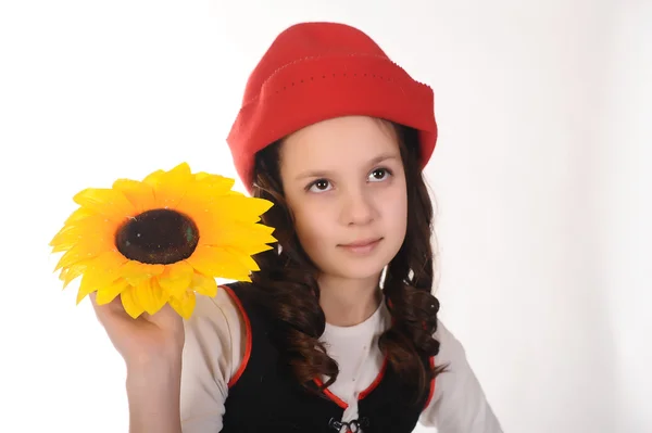 Girl in red hat with sunflowers in their hands — Stock Photo, Image