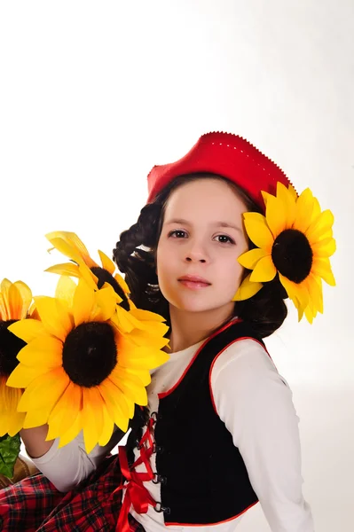 Girl in red hat with sunflowers in their hands — Stock Photo, Image