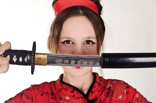 A girl handling a long samurai sword — Stock Photo, Image