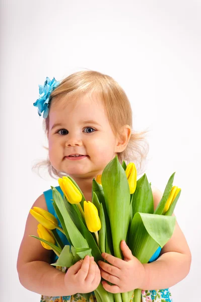 Menina com um monte de tulipas — Fotografia de Stock