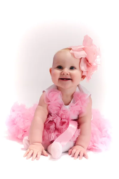 Baby girl wearing pettiskirt tutu and pearls crawling Stock Picture